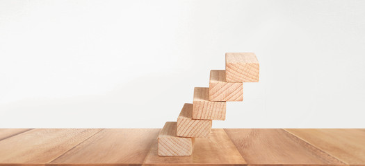 Wealth staircase concept.Chess figures on toy wooden ladder