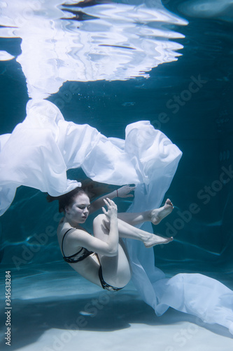 Beautiful And Sexy Girl Swims Underwater With Long Hair Blue Or Gold  Background, Like Gold The Atmosphere Of A Fairy Tale Or Magic Glossy Diving  Underwater Artistic Wall Mural | Artist-Underwater girls