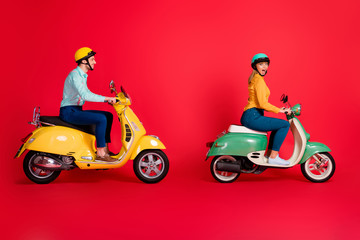 Profile side view of her she his he nice attractive positive cheerful cheery couple driving vehicle traveling having fun time isolated on bright vivid shine vibrant red color background