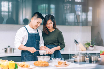 Young Adult Couple Food Cooking Together in the Kitchen at Home