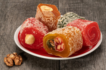 Pieces of Turkish delight and walnut on an old wooden tabletop