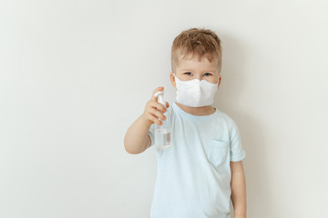 Boy in Medical Face Mask Hold Sanitiser Bottle. Caucasian Child Wearing Flu Protection Looking at Camera. Toddler Showing Antiseptic, Sterilization Gel. Corona Virus Pandemic Concept