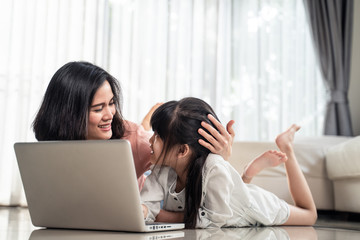 Homeschool Asian little young girl feel relax, learning internet online class by using computer...