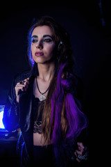 Girl in werewolf style on a black background with blue light.