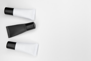 Tubes with cosmetics on a white background.