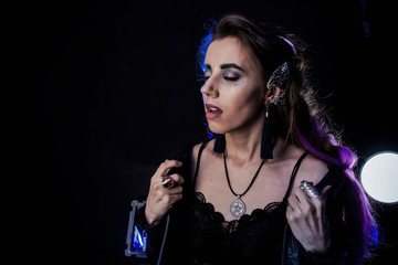 Girl in werewolf style on a black background with blue light.