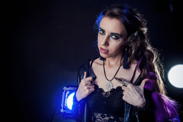 Girl in werewolf style on a black background with blue light.