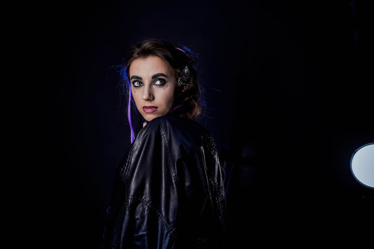 Girl in werewolf style on a black background with blue light.