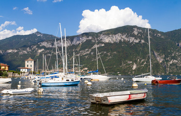 Fototapeta na wymiar A small boat in a body of water with a mountain in the background. High quality photo