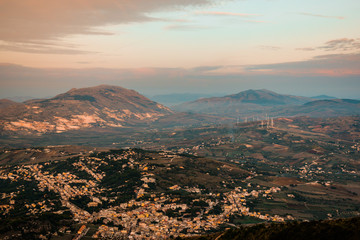 Amazing view seen from Erice Mountain, Sicily, Italy. In the landscape Trapani region, rocks, forest, buildings, cityscape. Shot during sunset, with beautiful sky colors.