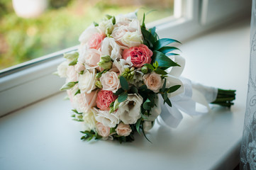 Colorfull bouquet of flowers on the white window sill