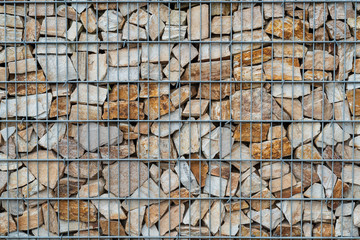 Gabion stone wall with metal grid as background