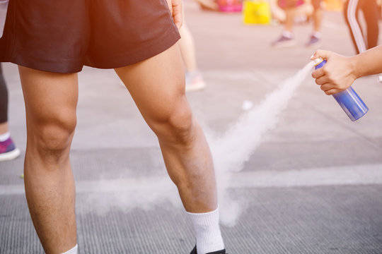 Sports Doctor Treating Injured Sportman's Leg