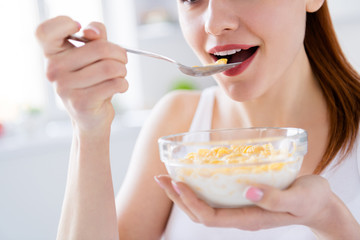 Closeup cropped photo of pretty housewife lady sit morning kitchen have breakfast eat cereal corn flakes milk stay home distance remote work good mood quarantine time indoors