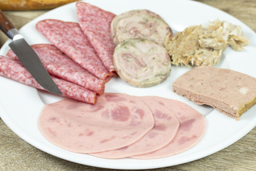 assiette de charcuterie et baguette de pain sur une table
