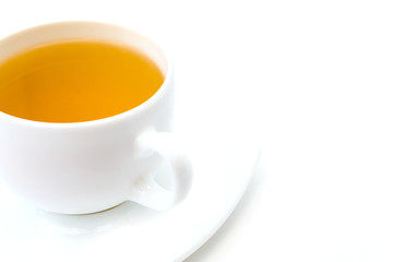 White porcelain cup with freshly brewed green tea isolated on white background.