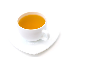 White porcelain cup with freshly brewed green tea isolated on white background. Selective focus