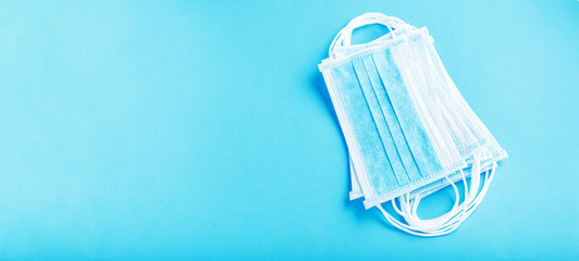 Medical mask, Medical protective masks on blue background. Disposable surgical face mask cover the mouth and nose. Healthcare and medical concept. Long web banner coronavirus covid-19 concept