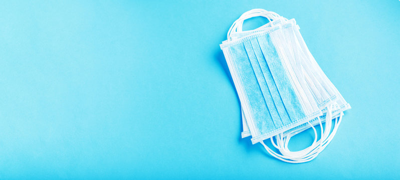Medical mask, Medical protective masks on blue background. Disposable surgical face mask cover the mouth and nose. Healthcare and medical concept. Long web banner coronavirus covid-19 concept