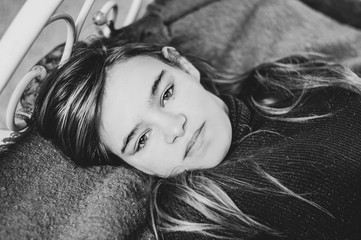 Black and white portrait of happy young woman laying on bed. relaxing.
