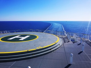 The trail of a ship on a clam blue sea.