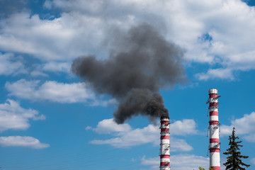 industrial smoke from chimney on blue sky