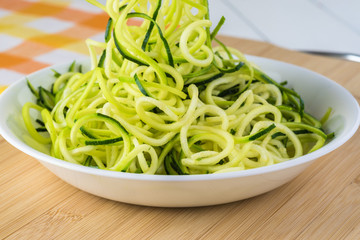 Spiral zucchini noodles salad with variety vegetables.