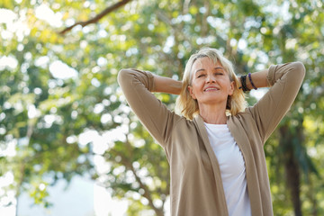 Elder retire woman stretch and relax feel fresh in the morning outdoor