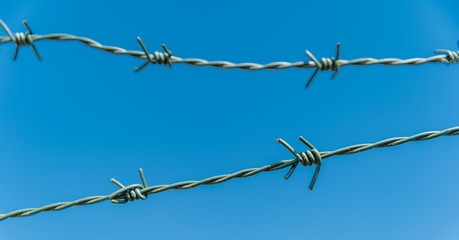 barbed wire with blue sky in the background