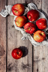 Crop of apples. Juicy summer red,orange, yellow and green apples on a wooden   background