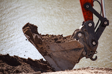 Shovel of excavator is digging the earth
