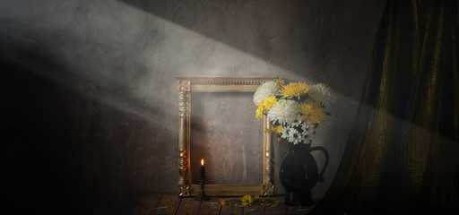 still life with chrysanthemums and  golden wooden frame on  background  old wall