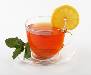 glass mug of tea with mint leaves and lemon, white background, isolate © Богдан Стеблянко