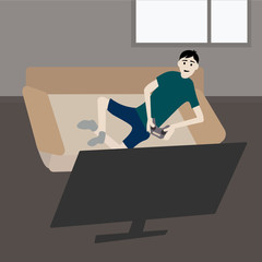 The guy lies on the couch, holds a joystick in his hands and plays the console. Stay home concept.