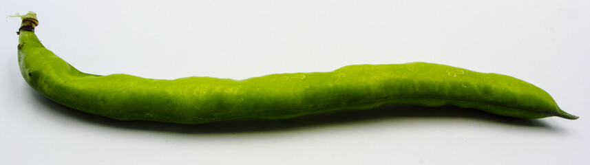 panoramic view of fresh green broad beans in their shells isolated on a white background