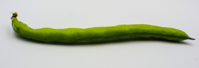 panoramic view of  fresh green broad beans in their shells isolated on a white background