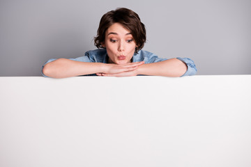 Photo of cheerful lady leaning hands on big empty paper poster proposing buy advertisement place...