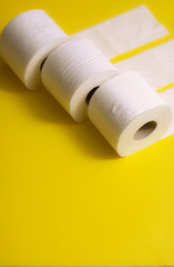 Toilet paper on yellow background, 