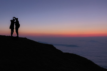 Silhouette of Lovers on twilight  and mist background at the morning in Phu Che Duan,Chieng Rai...