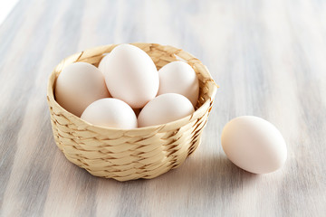 Organic white eggs in basket