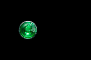 Top view of cup with green liquid on black