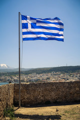 Greek flag in front of mountains