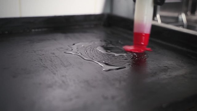 the chef with a brush spreads the pan with sunflower oil