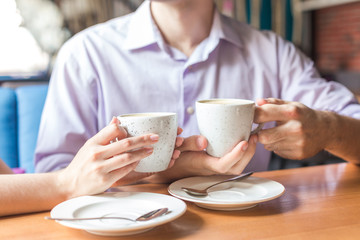 young man drinking coffee in cafe