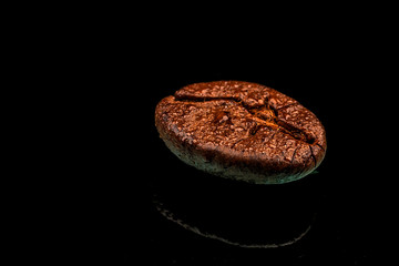 a single coffee bean macro shot with water drops and reflection. Black background