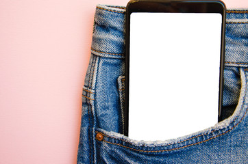 White screen smartphone in jeans pocket. Smartphone place for text. Smartphone in a pocket on a pink background.  Copy Space