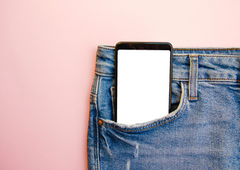 White screen smartphone in jeans pocket. Smartphone place for text. Smartphone in a pocket on a...