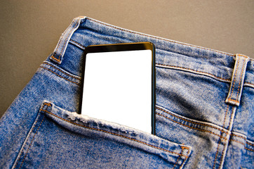 White screen smartphone in jeans pocket. Smartphone place for text. Smartphone in a pocket on a black background.  Copy Space