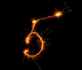 number five written with a sparkler on a black background