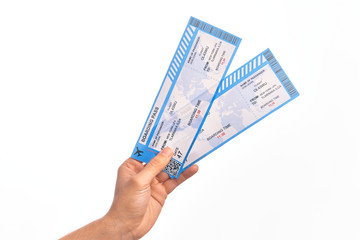 Hand of caucasian young tourist man holding airplane boarding pass over isolated white background - obrazy, fototapety, plakaty